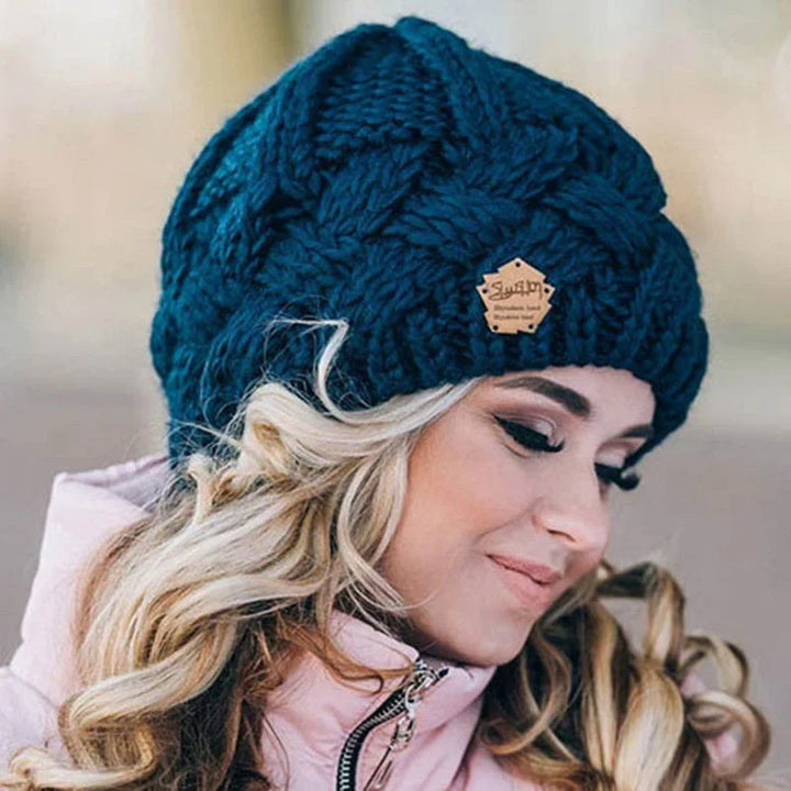 Close-up of a soft, chunky knit women's winter hat. Cozy beanie for cold weather.