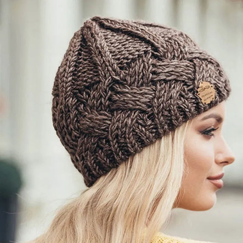 Woman wearing a warm, stylish knitted beanie. Perfect winter accessory for fashion and comfort.