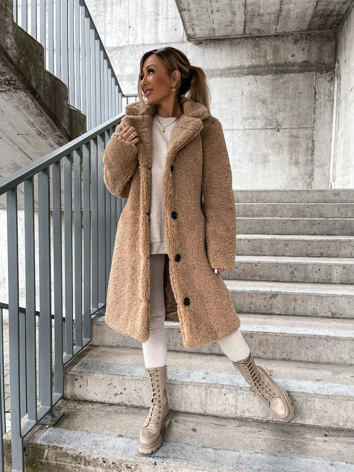 Women's cozy longline plush teddy coat, a warm and soft outerwear for elegant fall and winter fashion.