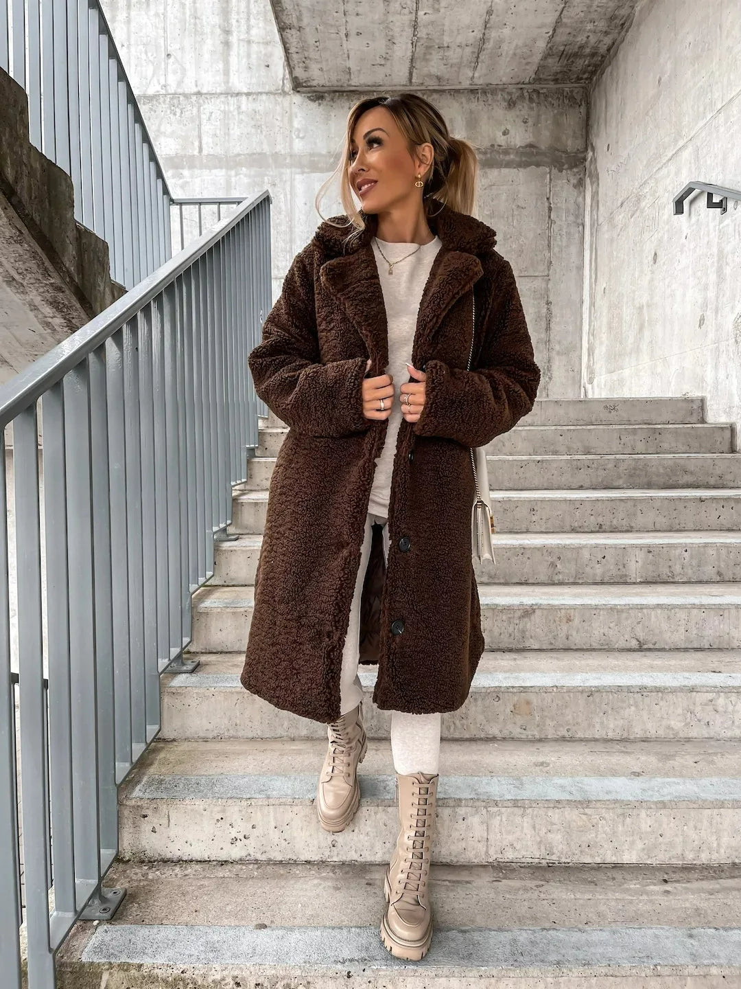 Women's warm longline plush teddy coat, essential cozy outerwear for chilly fall and winter days.