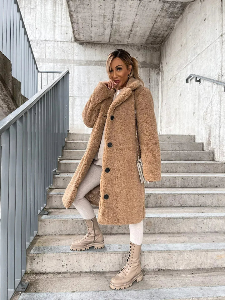 Chic women's plush longline teddy coat, a comfortable trench coat style for elegant winter outerwear.
