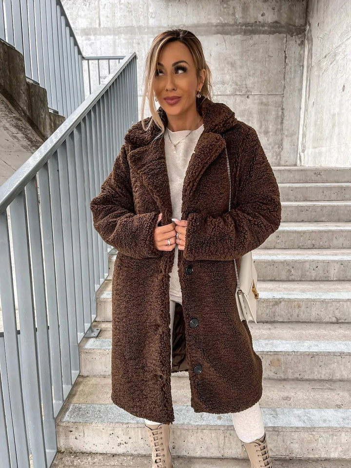 Soft women's longline plush teddy coat, providing ultimate warmth and style for winter outerwear.