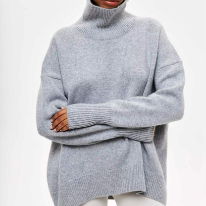 Women's oversized turtleneck pullover styled for layering, offering warmth and comfort for cold weather.