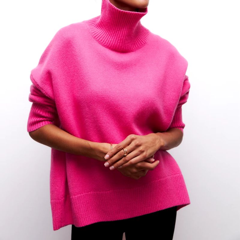 Close-up of soft knit fabric on a women's cozy oversized turtleneck pullover, ideal for loungewear.