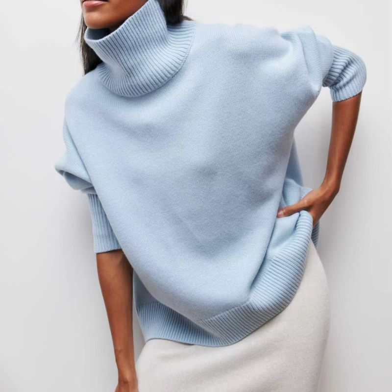 Woman wearing a relaxed fit oversized turtleneck pullover, ideal for casual wear & layering in winter.
