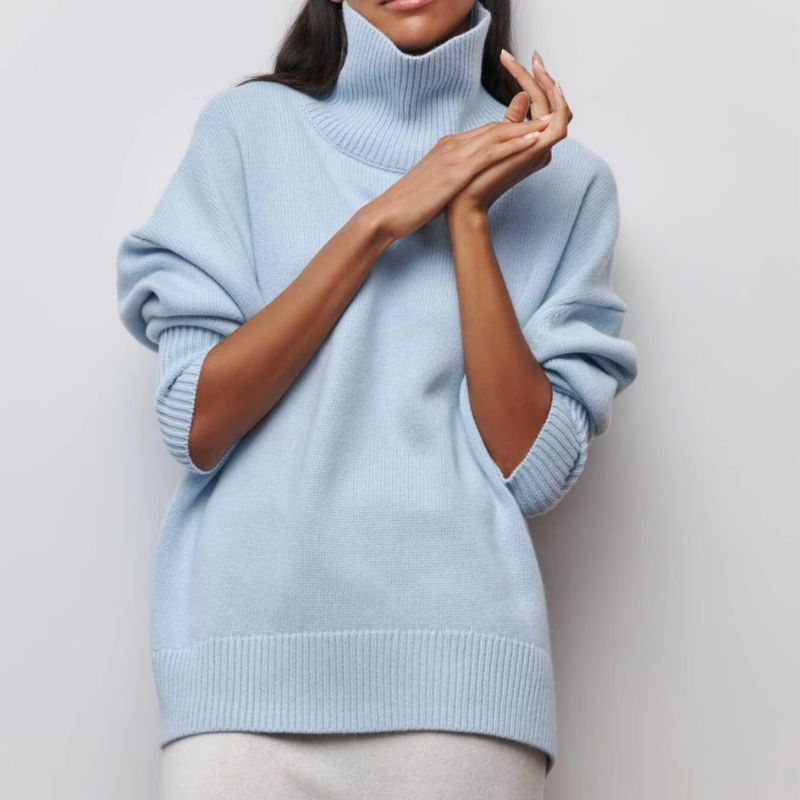 Women's oversized turtleneck pullover paired with jeans, showcasing a comfortable and stylish fall fashion look.