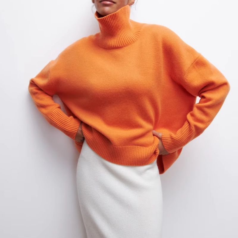 Detail of the comfortable turtleneck collar on a women's cozy oversized pullover, perfect for winter warmth.
