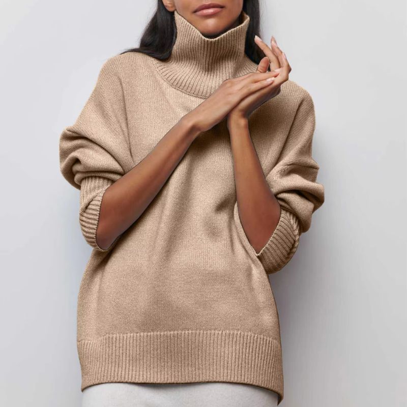 Woman relaxing in a cozy oversized turtleneck pullover, perfect loungewear for ultimate comfort and winter style.