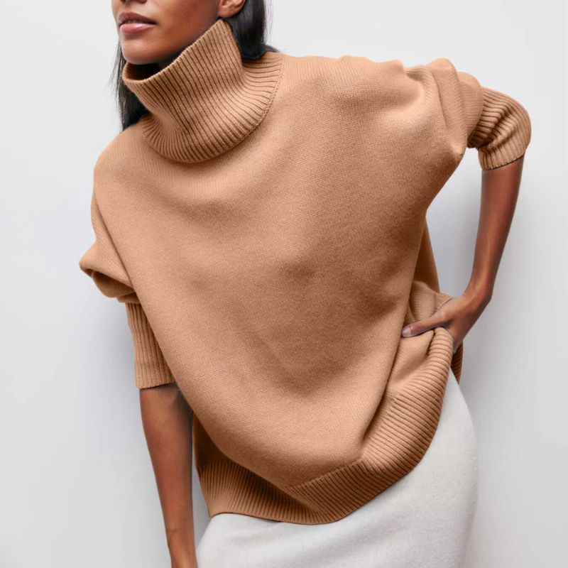 Folded women's oversized turtleneck pullover in soft knit, a cozy and comfortable addition to fall wardrobes.