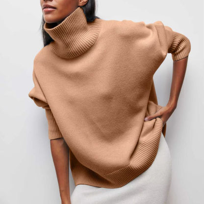 Folded women's oversized turtleneck pullover in soft knit, a cozy and comfortable addition to fall wardrobes.