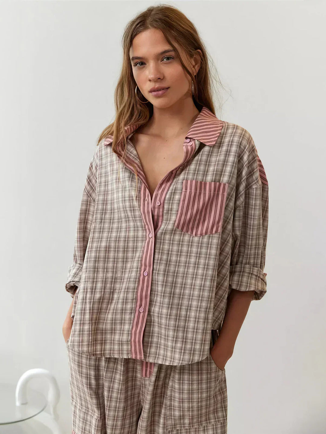 Women's cozy plaid button-up pajama set. Two-piece loungewear for comfortable sleep and relaxed home wear.