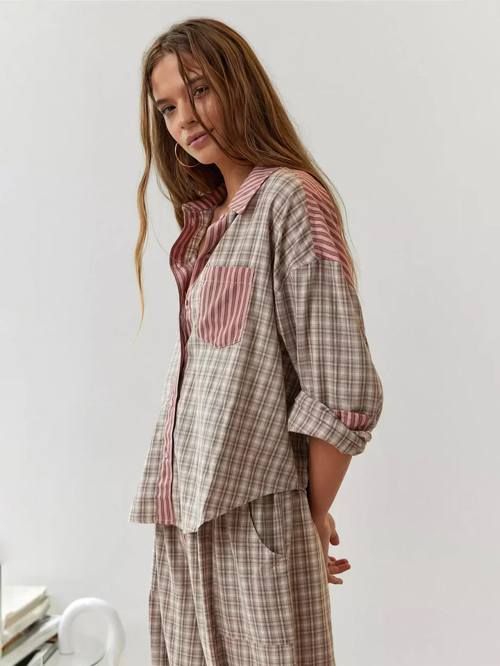 Soft women's plaid sleepwear set, perfect for comfortable lounging. Features a button-up top and matching pants.