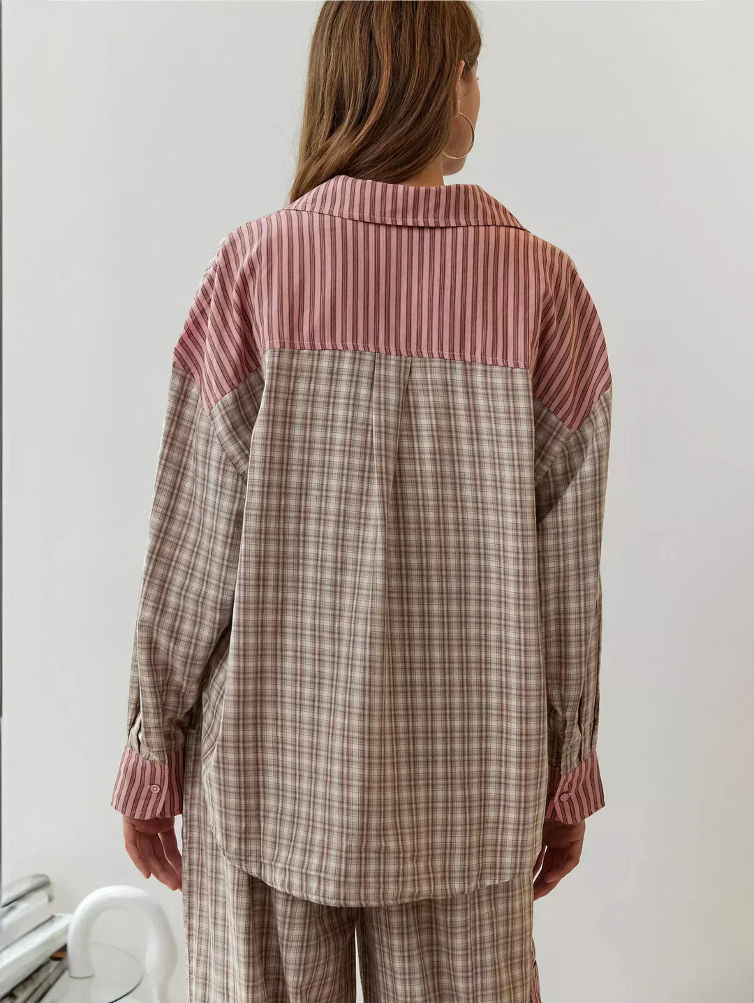 Comfortable women's plaid two-piece pajama set. Stylish button-front sleepwear for cozy nights and home relaxation.