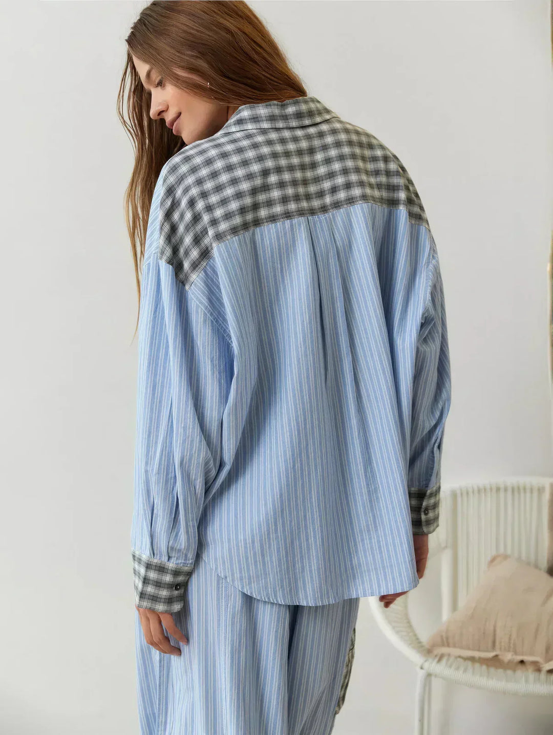 Stylish women's plaid pajama set with button-up top and long pants. Comfortable loungewear for relaxing at home.