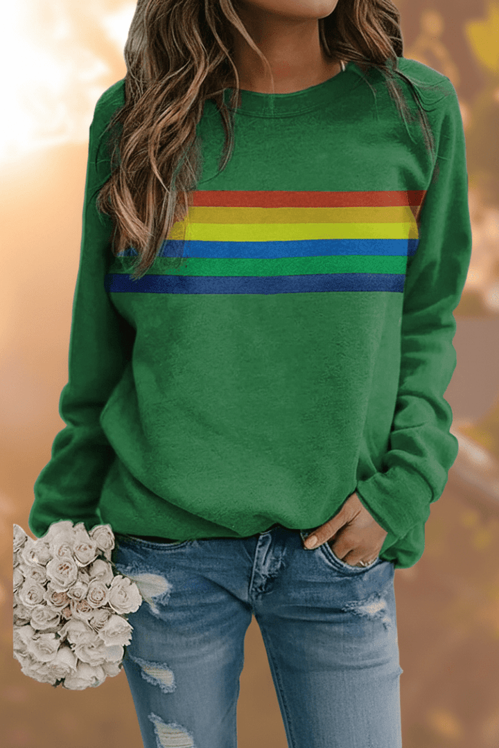 Woman wearing a comfortable women's rainbow striped pullover sweatshirt. Casual, cozy everyday look.