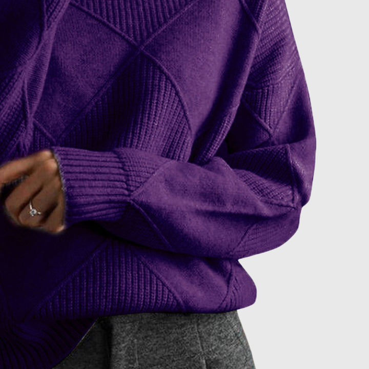 Folded women's elegant roll neck sweater, showcasing its quality and readiness for winter.