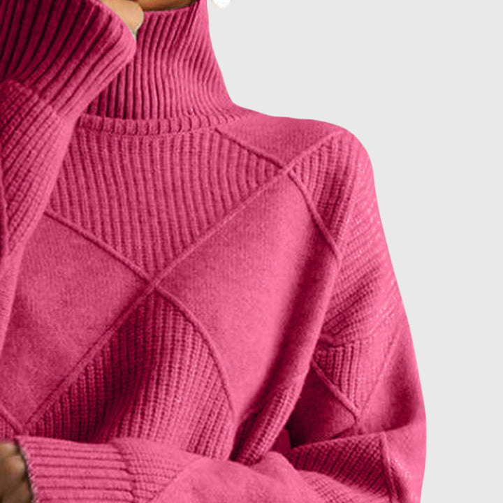 Oversized women's sweater featuring a soft roll neck and modern diagonal seam detailing.