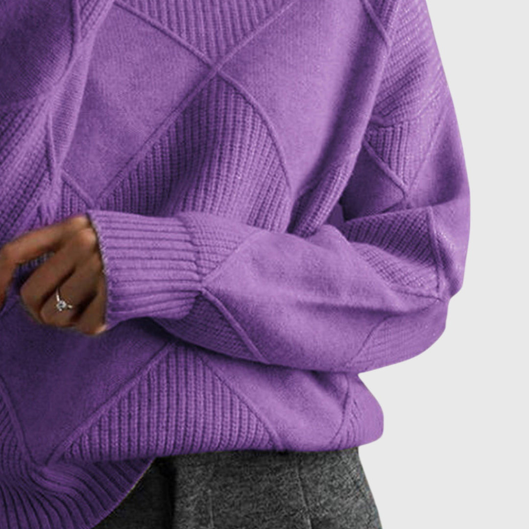 Full view of a woman confidently wearing the stylish, relaxed fit turtleneck sweater.