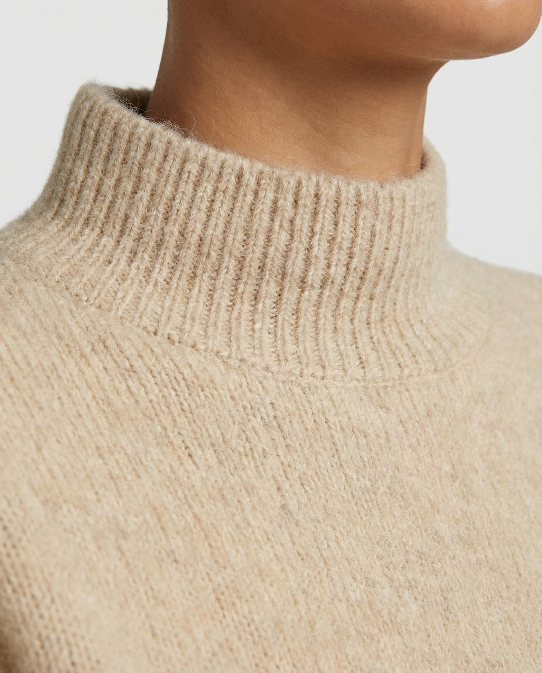 Chic women's textured turtleneck sweater, offering warmth and style for a cozy winter fashion look.