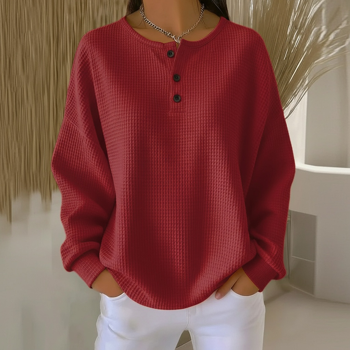 Relaxed fit women's long-sleeve waffle knit sweater. Ideal cozy top for winter wear and casual fashion comfort.