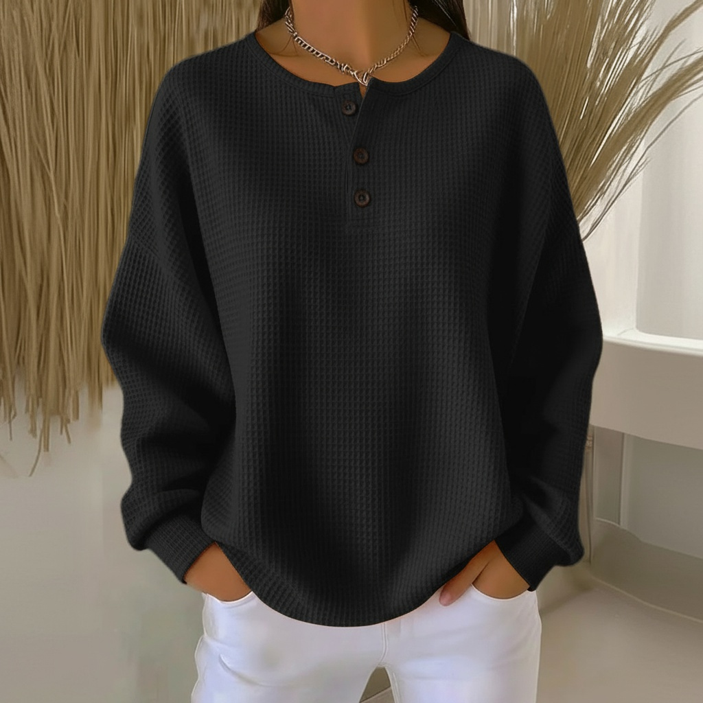 Woman wearing a cozy beige waffle knit sweater, showcasing its relaxed fit and soft texture for fall fashion.