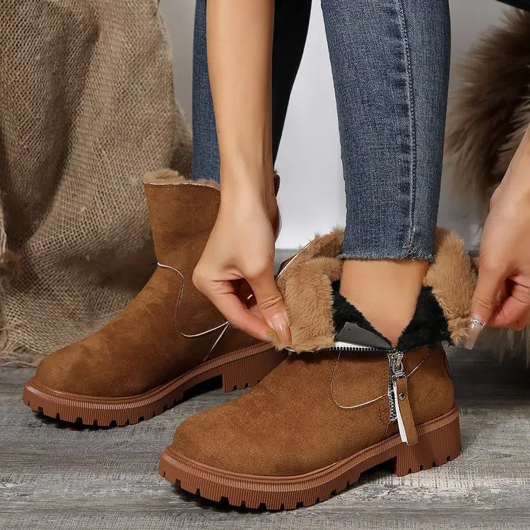Women's black winter boots with faux fur trim and practical zipper, perfect for snowy adventures.