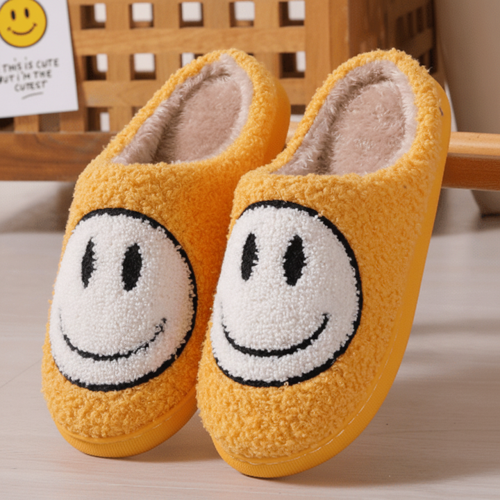 Women's cozy winter slippers featuring a happy smiley face design and a supportive, thick sole for warmth.