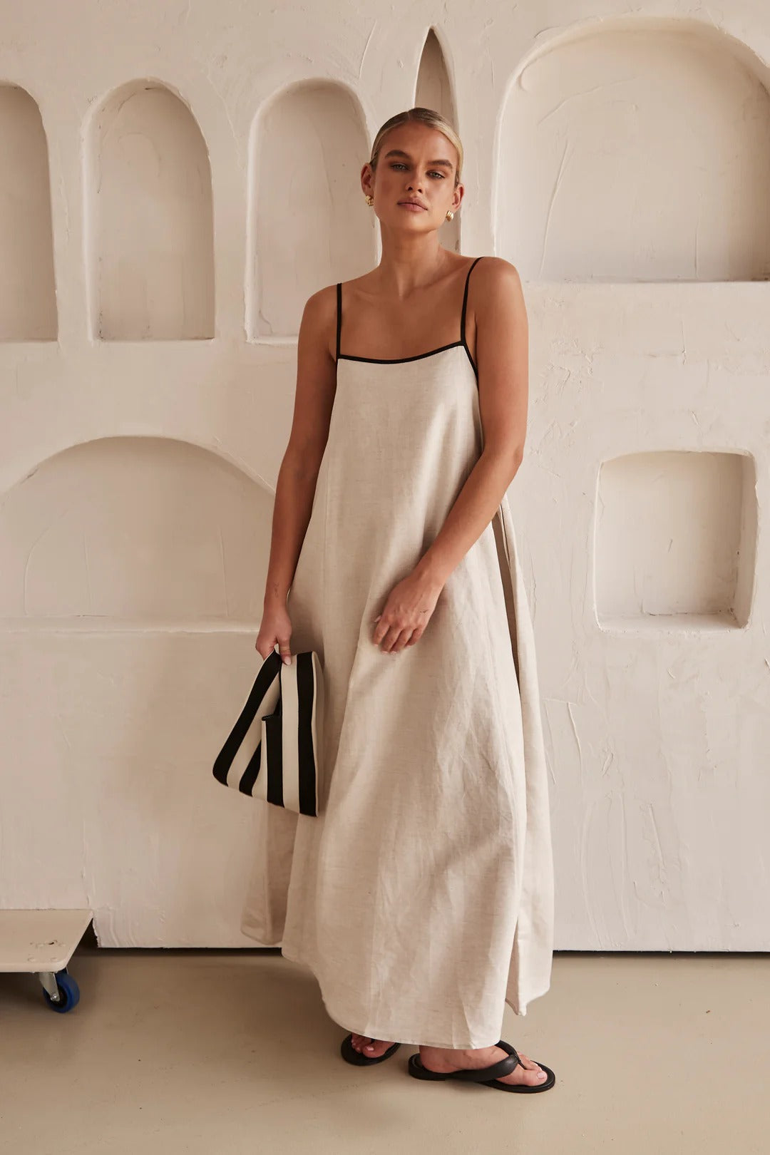 Women's cream maxi dress with contrast trim, square neck, spaghetti straps. Elegant summer resort wear. A-line fit.