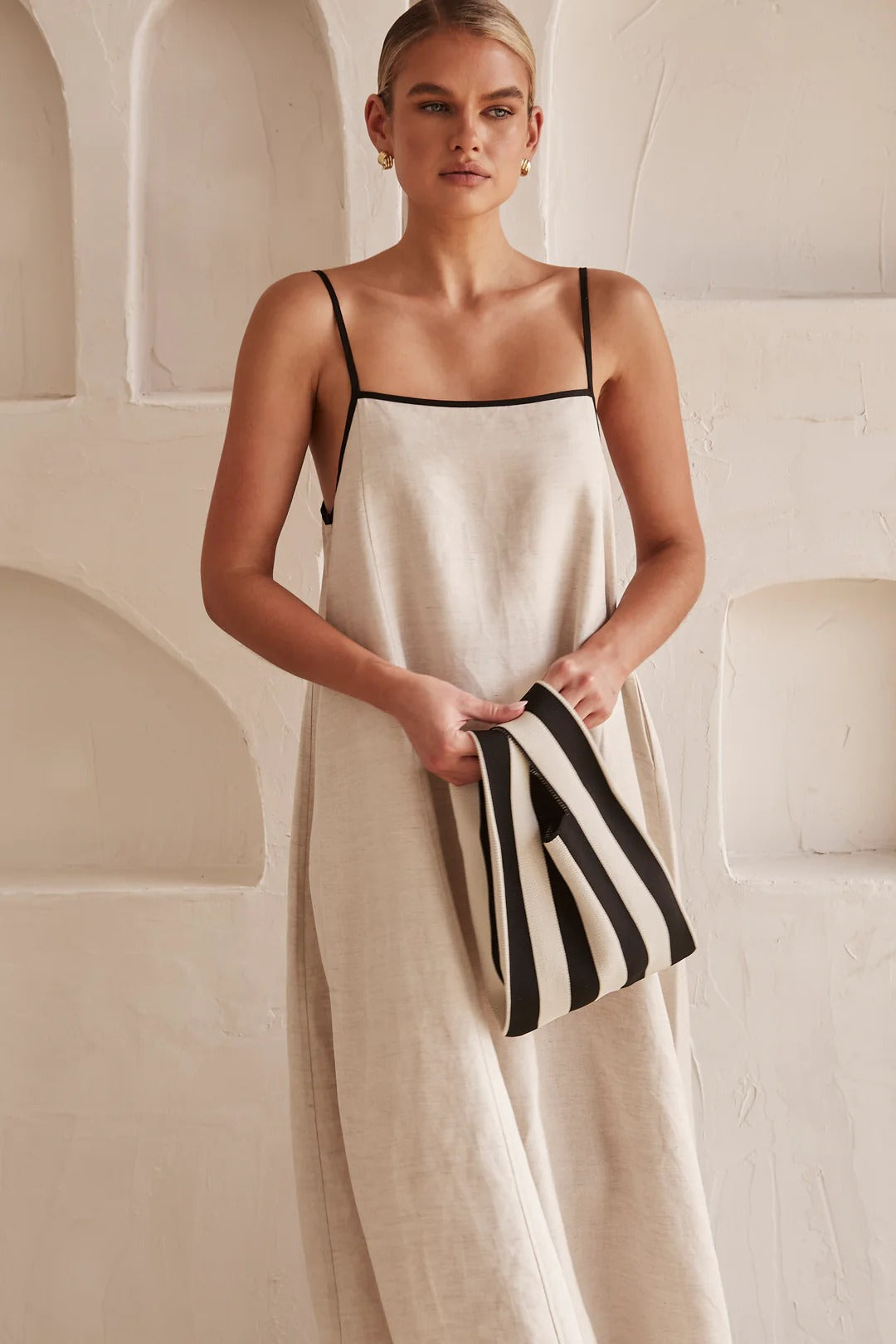 Elegant women's cream maxi dress featuring a square neck, spaghetti straps & stylish contrast trim. Ideal for summer resort.