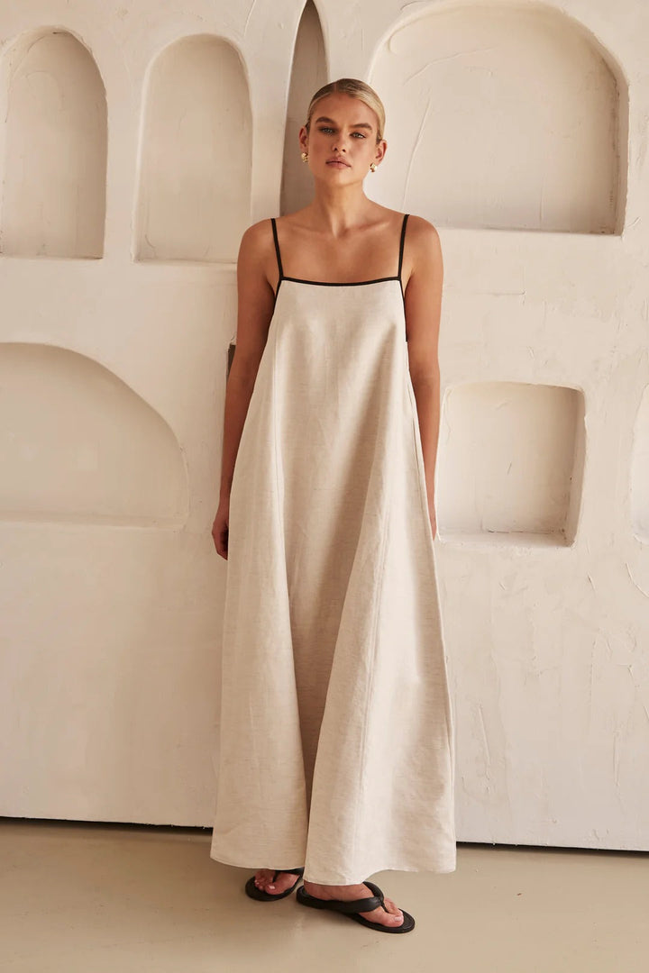 Full view of a women's cream maxi dress, featuring a square neck, spaghetti straps & stylish contrast trim. Summer elegant.