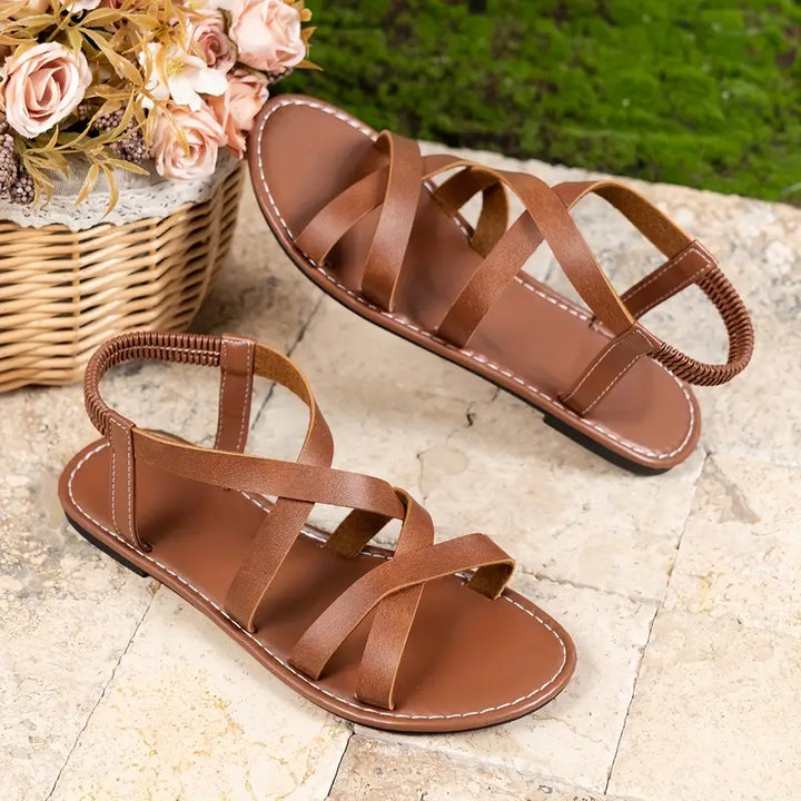 Fashionable and durable women's criss-cross strap flat sandals, designed for long-lasting summer wear.