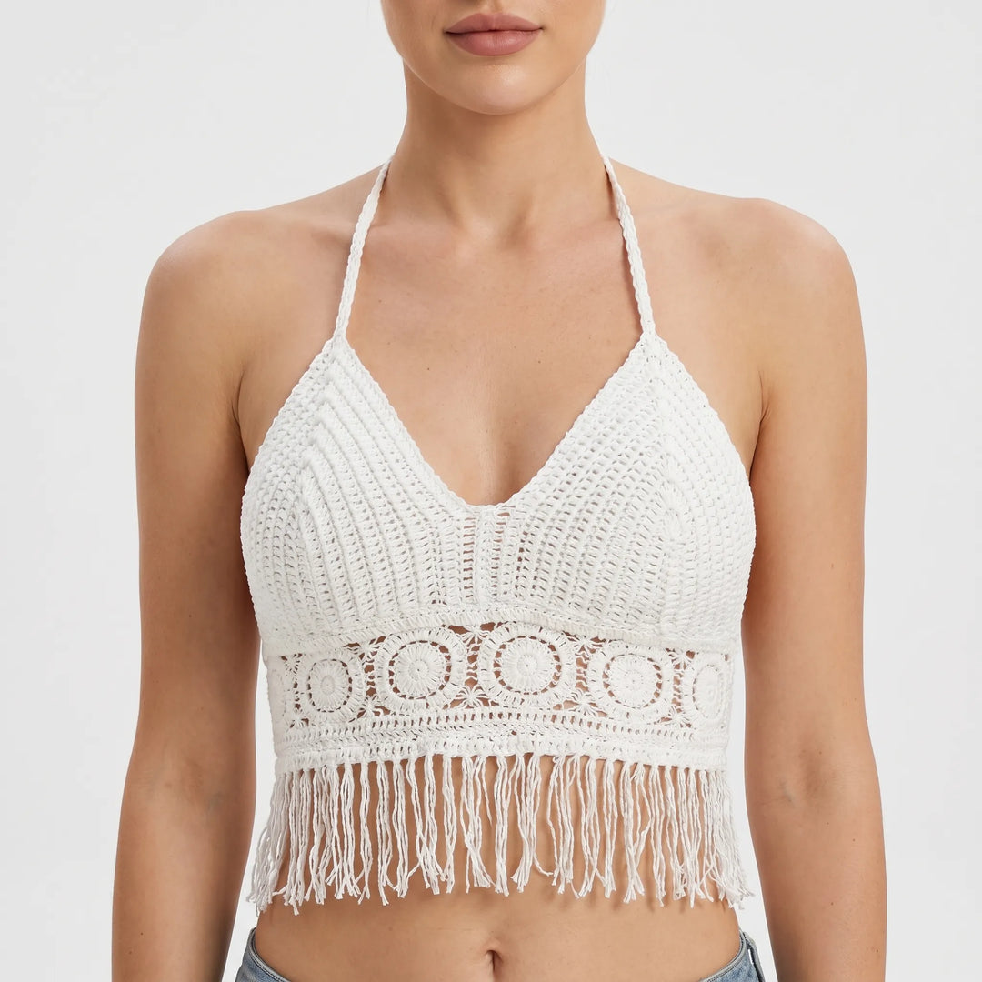 Bohemian women's crochet halter crop top with a chic fringe hem, perfect for festivals and vacation wear.