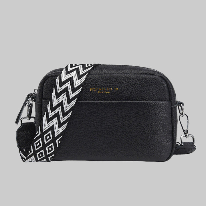 Women's crossbody bag with unique geometric strap. Versatile shoulder bag for everyday chic style.