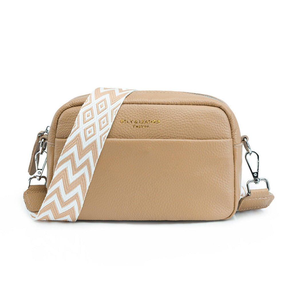 Fashionable blue women's crossbody shoulder bag featuring a geometric design strap. A versatile accessory.