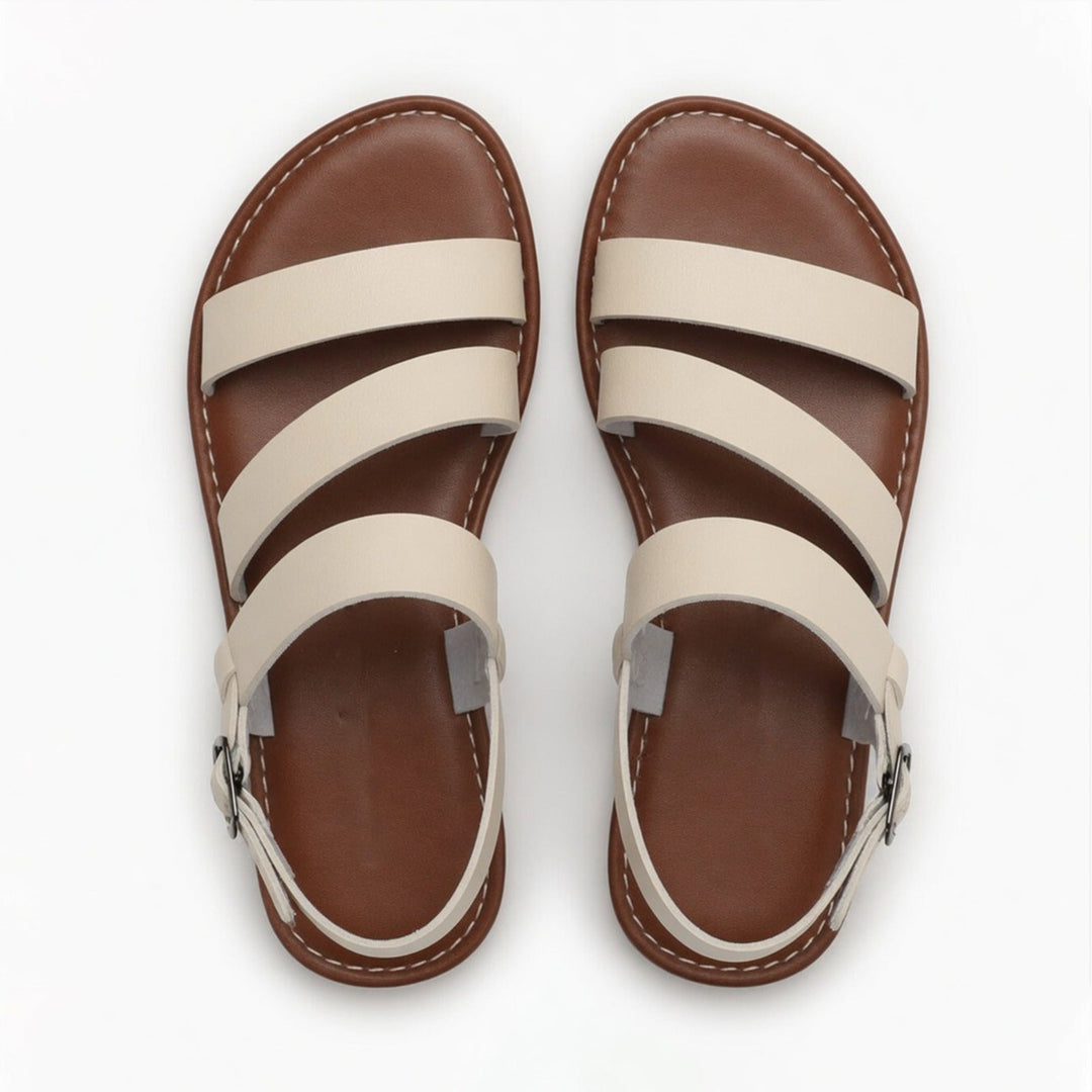 Relaxed women's slip-on flat sandals, featuring open-toe and crossover straps, perfect for summer comfort.