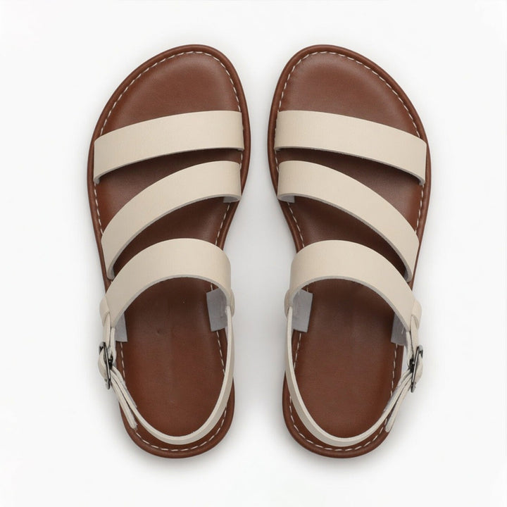 Relaxed women's slip-on flat sandals, featuring open-toe and crossover straps, perfect for summer comfort.