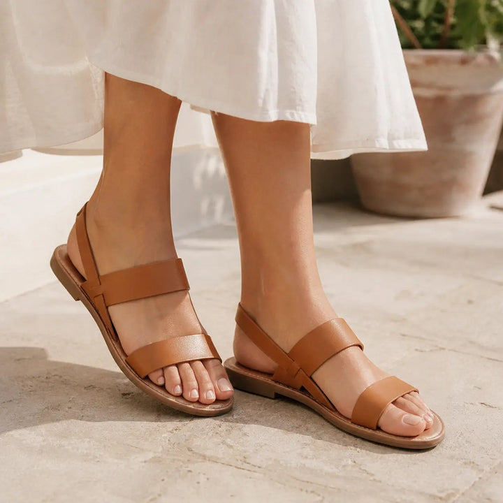 Stylish women's flat sandals with crossover straps & open toe, ideal summer shoes for beach & vacation.