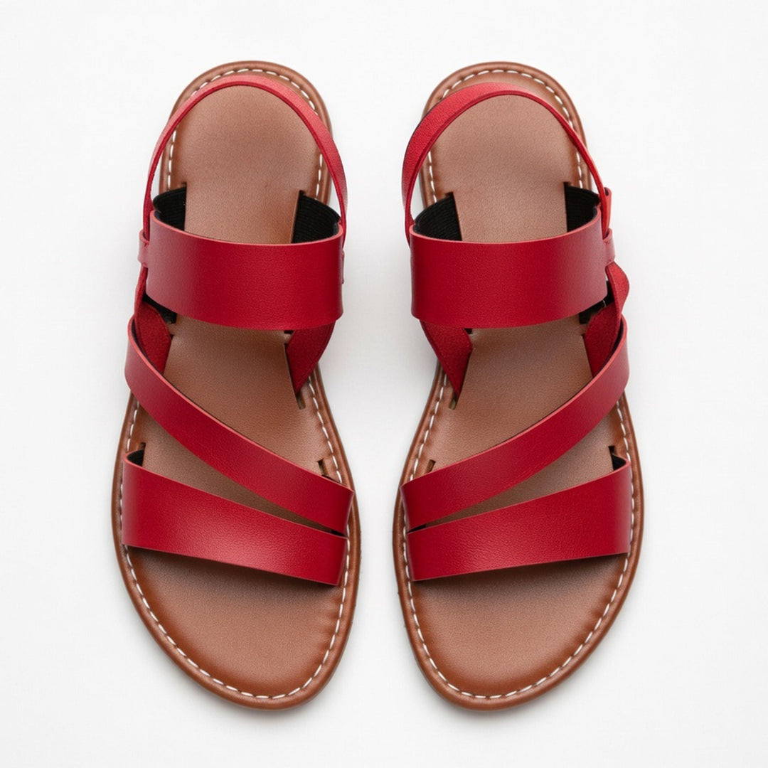 Chic women's open-toe flat sandals with crossover straps, perfect comfort footwear for summer & beach.