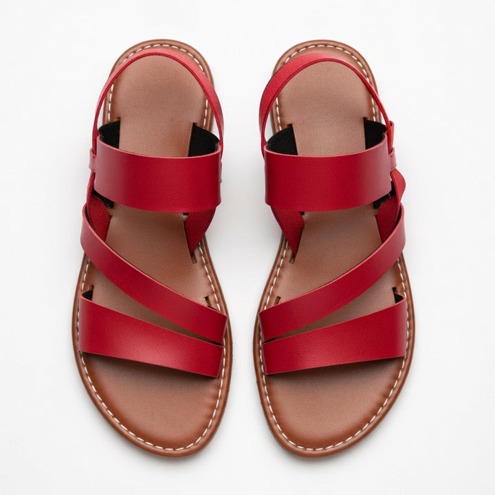 Chic women's open-toe flat sandals with crossover straps, perfect comfort footwear for summer & beach.