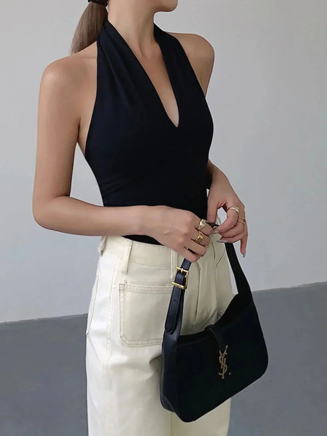 Stylish women's halter top featuring a flattering V-neck and sleeveless design. Ideal for casual summer wear.