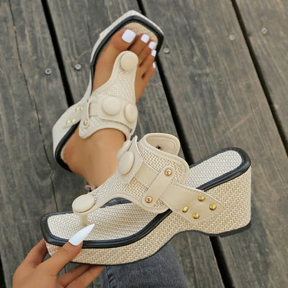 Modern women's platform slides, with a cushioned sole and distinctive studded accents.