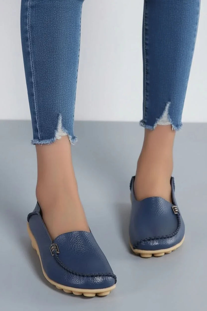 Stylish women's slip-on flats with a cushioned round toe, perfect for casual or travel wear.