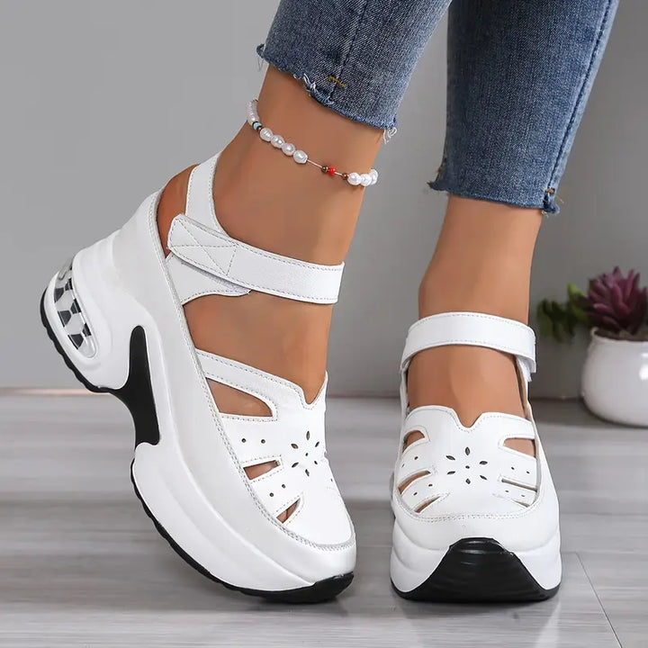 Comfortable women's walking sandals: cushioned wedge platform, breathable cutout, closed toe design.