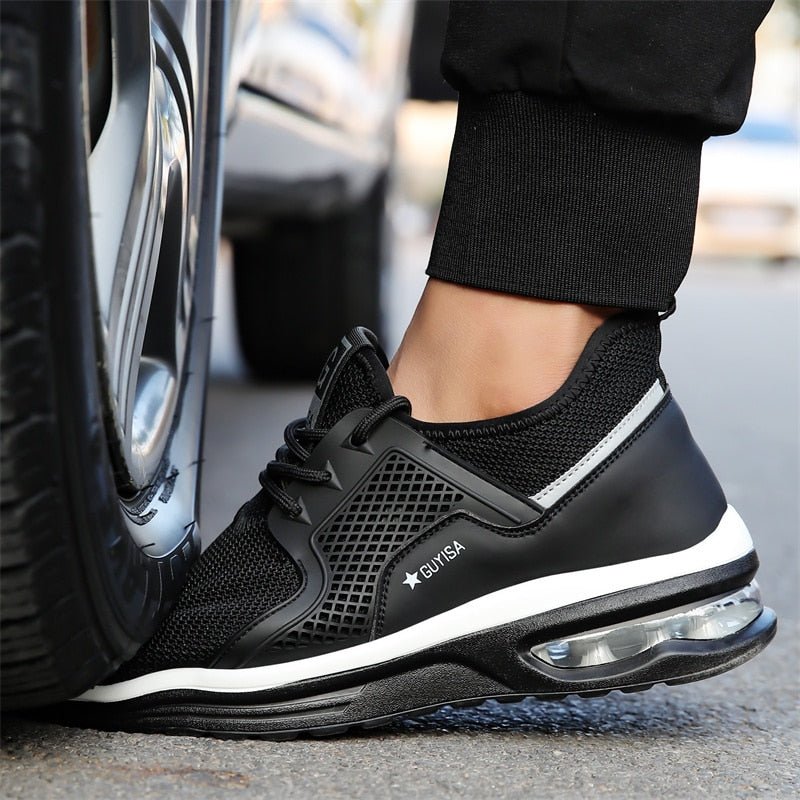 Side view of women's black protective work sneakers. Features orthopedic support, durable design, and slip resistance.