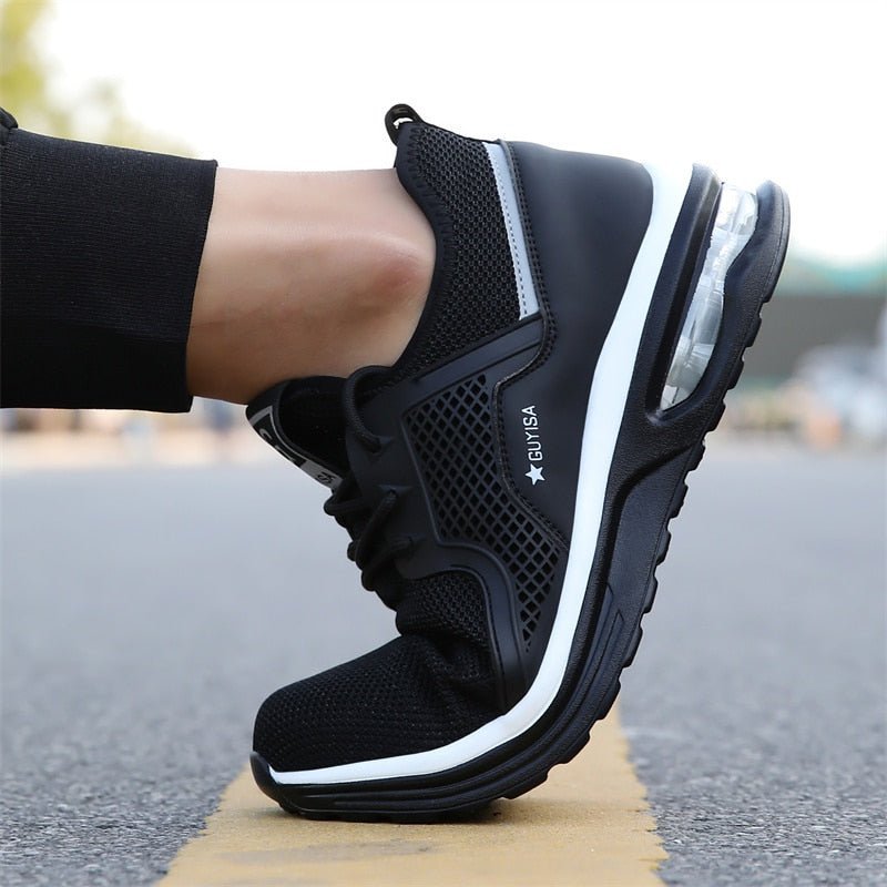 Sole view of women's slip-resistant safety sneakers in dark gray, designed for maximum traction and ergonomic comfort.