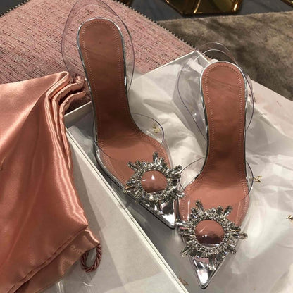 Glamorous women's transparent high heels with sparkling crystal details. Chic clear pumps for dressy occasions.