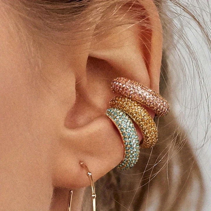 Women's dazzling pavé crystal no-piercing ear cuff, elegant gold-tone fashion accessory.