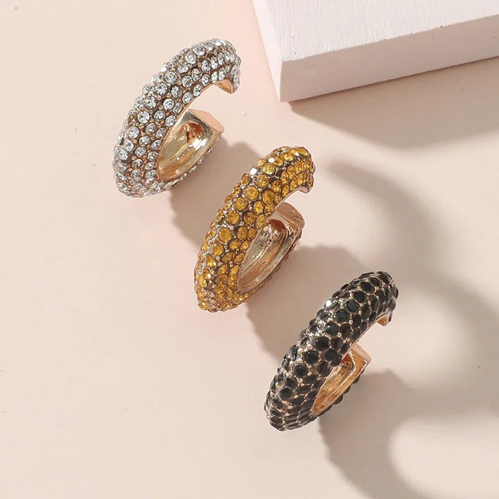 Dazzling pavé crystal no-piercing ear cuff, a sparkling women's gold-tone jewelry accessory.