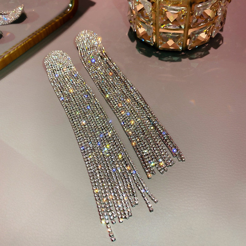 Dazzling long rhinestone drop earrings, an elegant accessory for formal wear and special occasions.