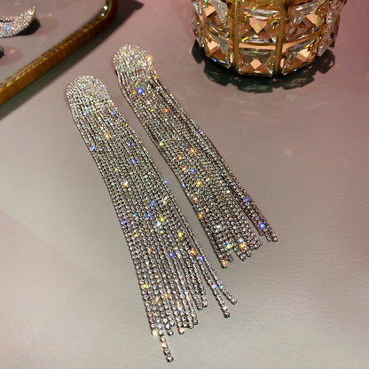 Dazzling long rhinestone drop earrings, an elegant accessory for formal wear and special occasions.